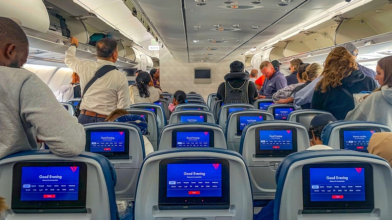 passengers loading bins on delta plane