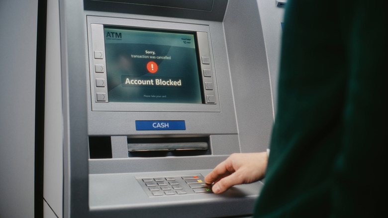 closeup of an ATM in use