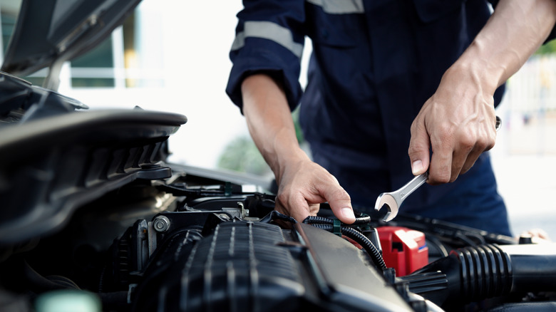 Mechanic working on a car engine.