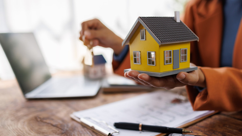 house figurine and mortgage documents