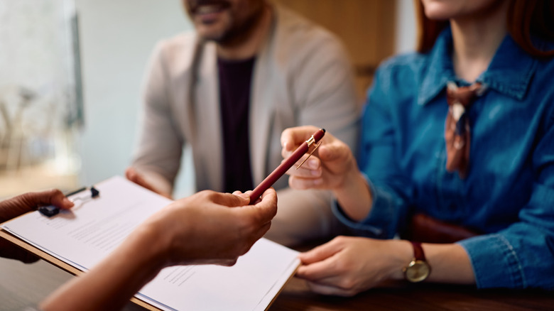 couple signing mortgage documents