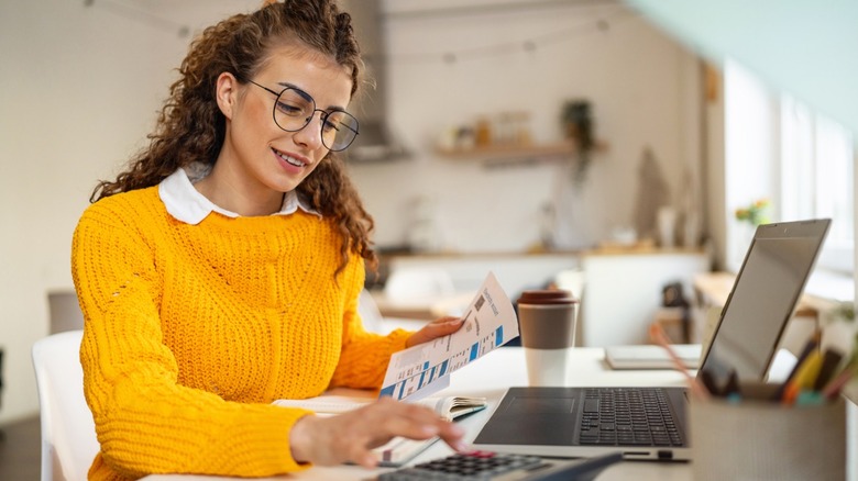A young woman reviewing financial information to set up an IRA account.