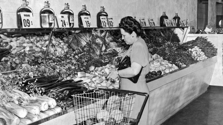 Vintage black and photo of woman shopping in grocery store.