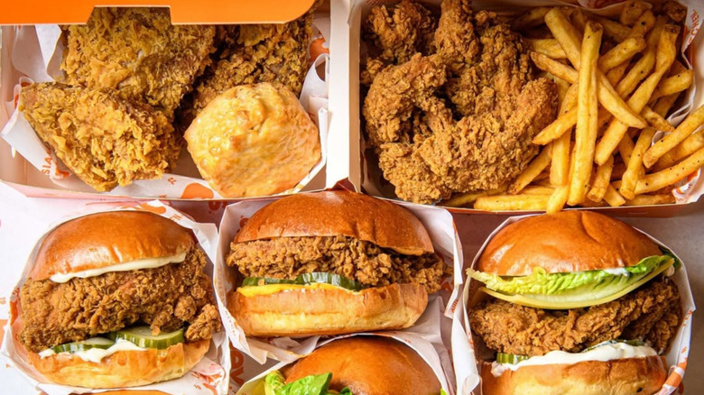 Overhead view of fried chicken baskets and fried chicken sandwiches.