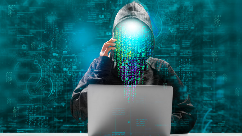 faceless hacker in front of laptop