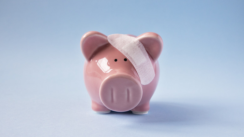 a piggy bank wearing a bandage