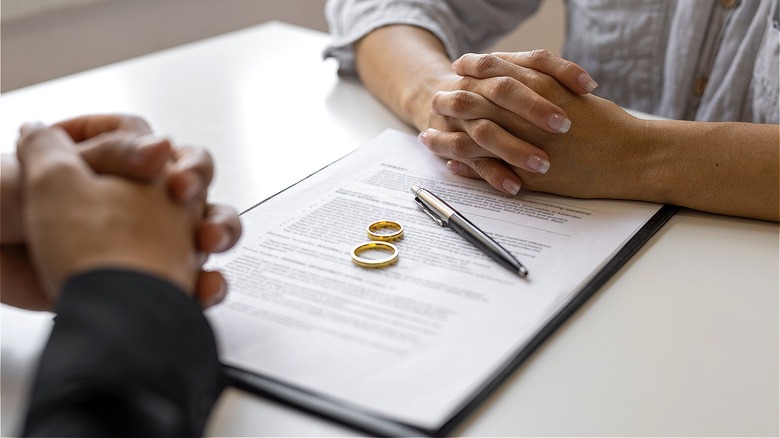 Couple with rings and paperwork