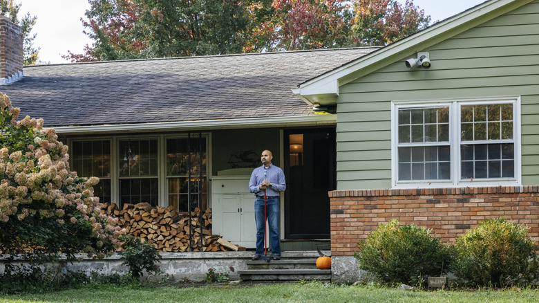 a guy standing on his porch