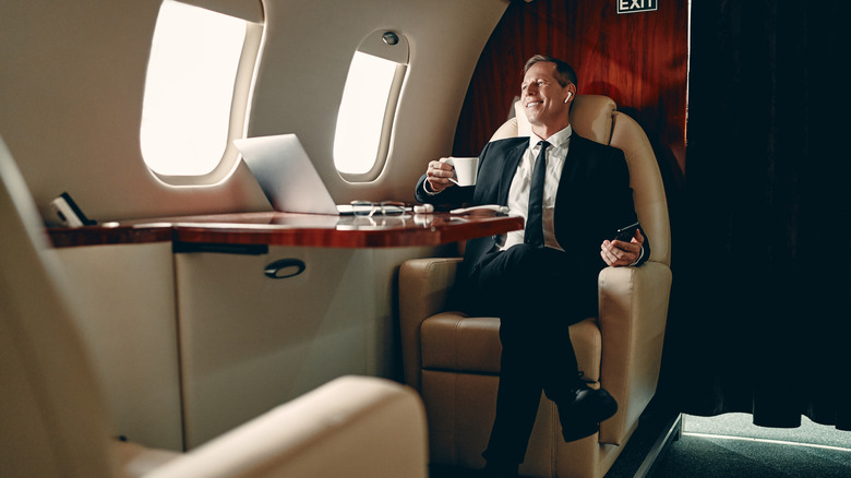 Businessman flying private and listening to music