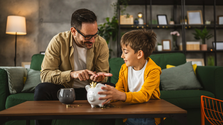 father and son with a piggy bank