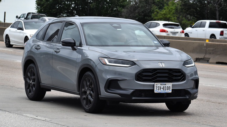 A gray Honda HR-V SUV traveling down a highway in moderate traffic
