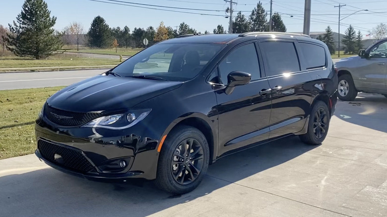 A black 2020 Chrysler Pacifica Launch Edition in the parking lot of a dealership on a sunny day