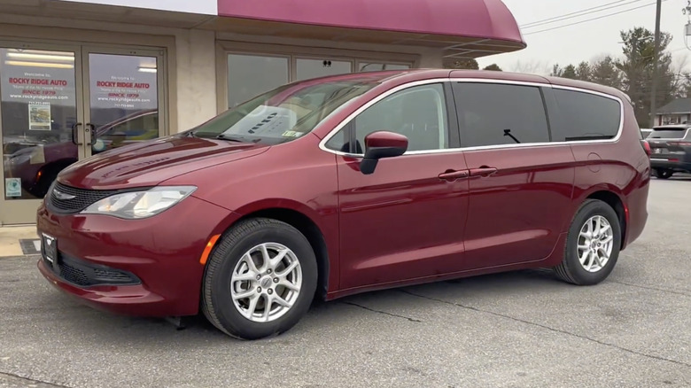 A burgundy 2022 Chrysler Voyager LX on display at a dealership