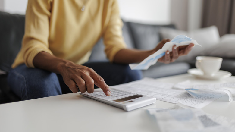 Middle-aged woman checking bills at home