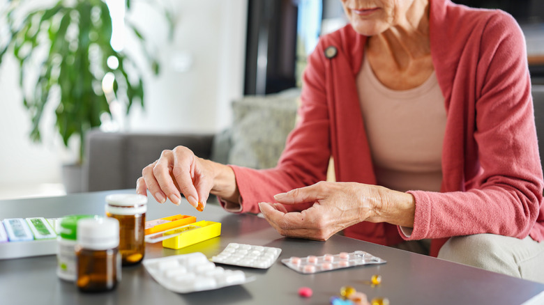 Older woman sorting out pills