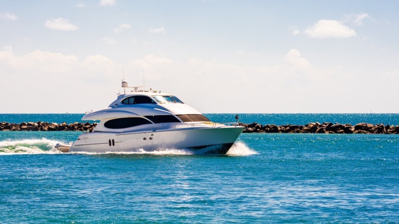 A yacht sailing on blue water on a sunny day.