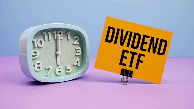 dividend ETF on a notecard next to clock