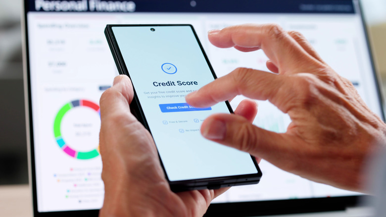 Person checking their credit score on a smartphone