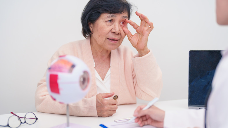 Older woman discussing eye trouble with a doctor