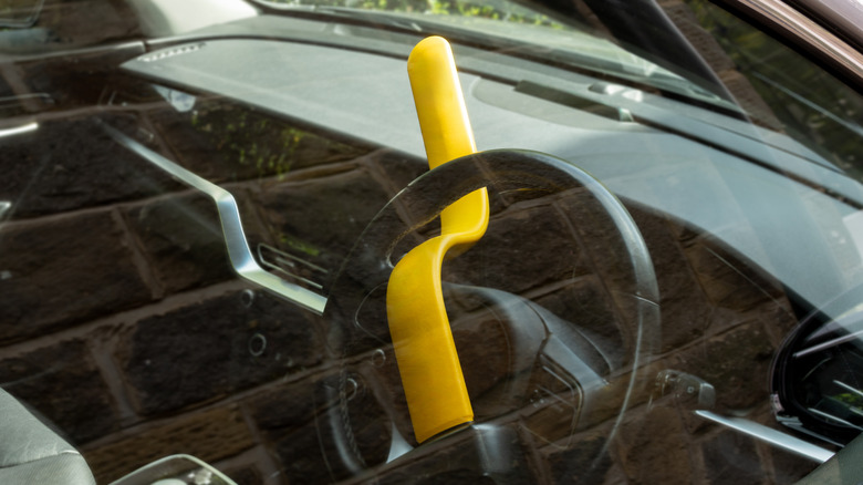 Anti-theft lock fitted to car steering wheel.