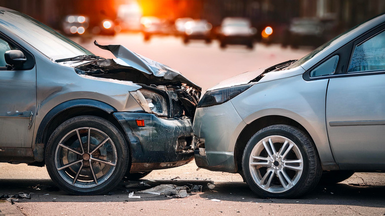 photo of two silver cars damaged in a forward collision