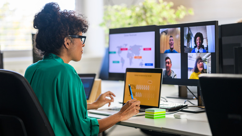 Professional woman participates in a video meeting with others