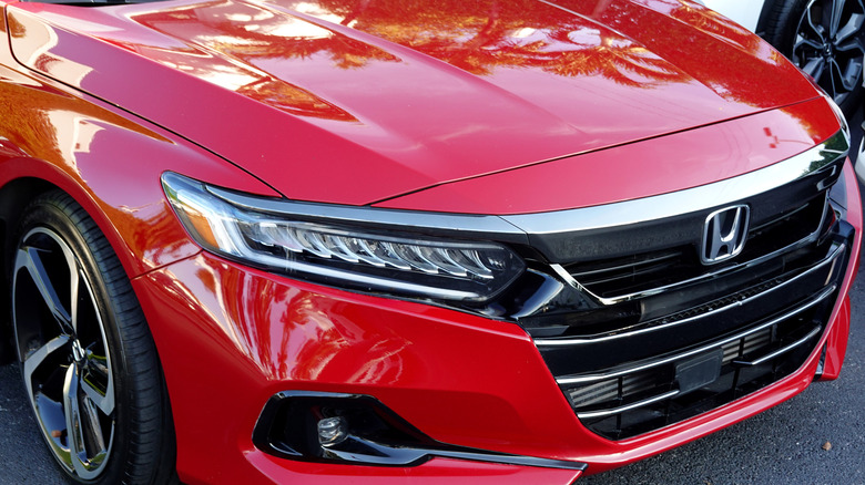 The front end of a red Honda Accord.