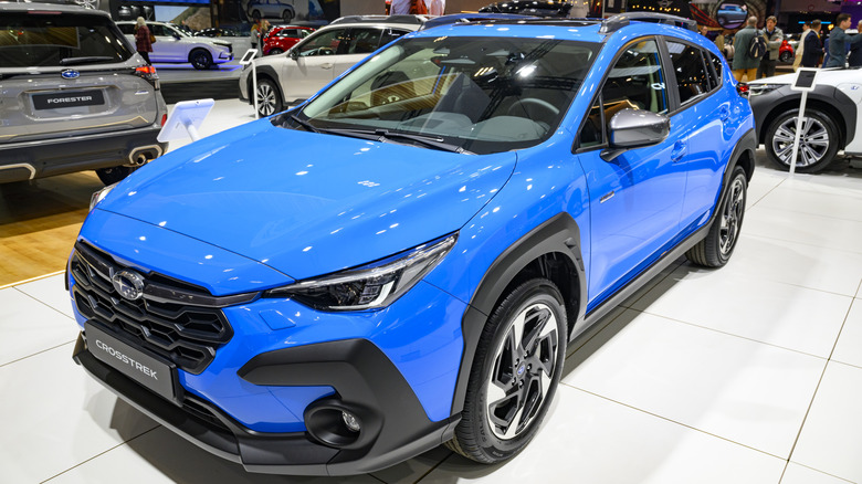 A blue 2026 Subaru Crosstrek at a car show.