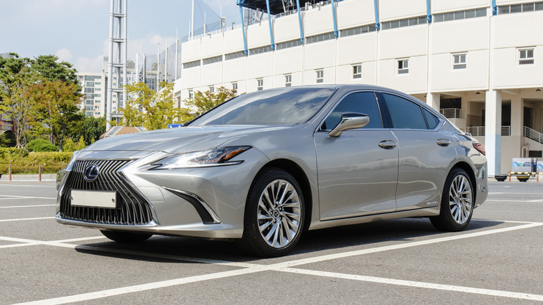 A silver Lexus ES300h hybrid luxury sedan parked in an outdoor parking lot.