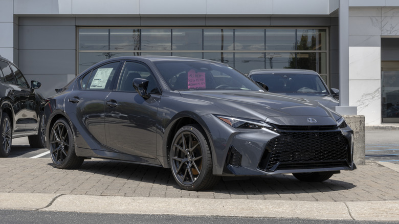 Lexus IS 350 F Sport Design AWD sedan display at a dealership.