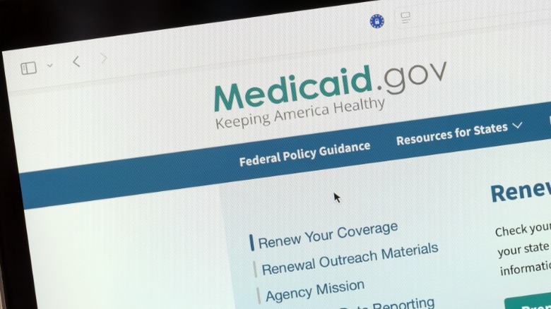 The homepage of the United States Medicaid system open on a laptop screen.