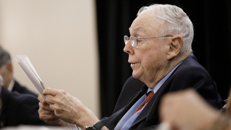 Charles Munger looking over papers