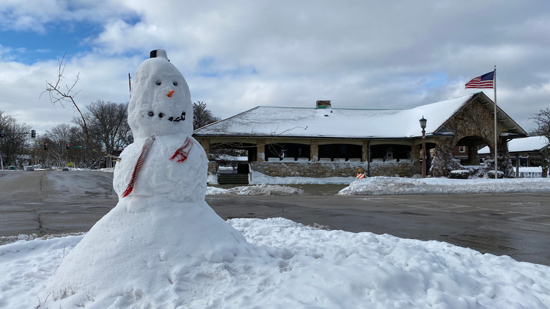 A snowman in Kenilworth, Illinois. Train station in the background.