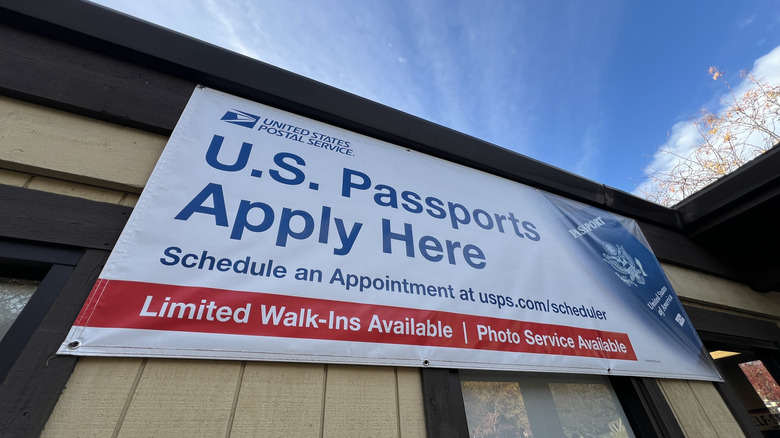 USPS sign attached to building advertising passport renewals.