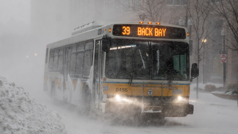 A MBTA bus drives through snowy weather