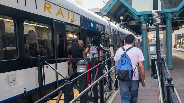 Jersey City passengers walk near light rail train