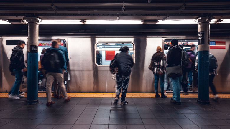 Slightly blurred image of people boarding an underground subway train