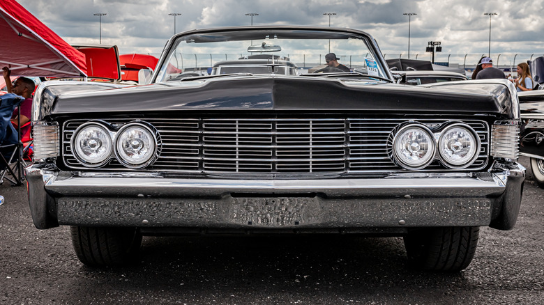 Classic car parked outside under clouds