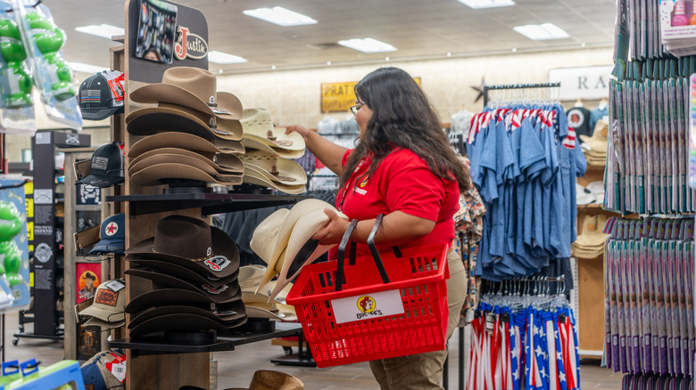 Buc-ee's employee places branded hats on display