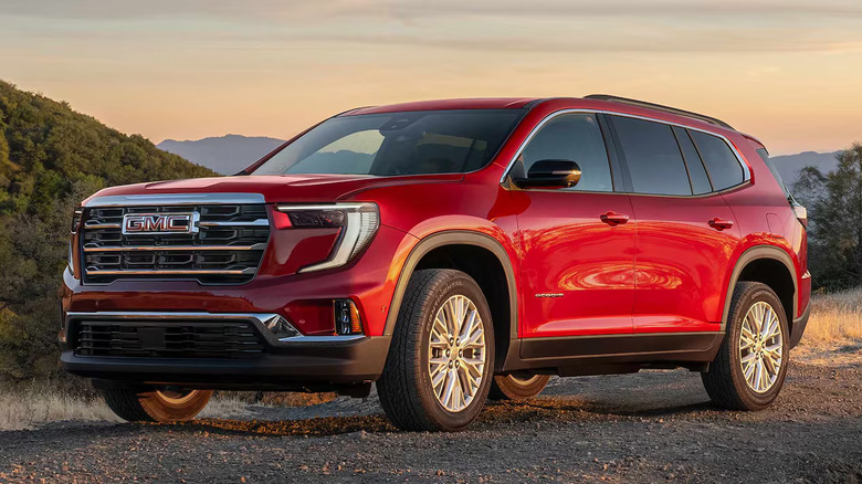 red GMC Acadia with hills in the background