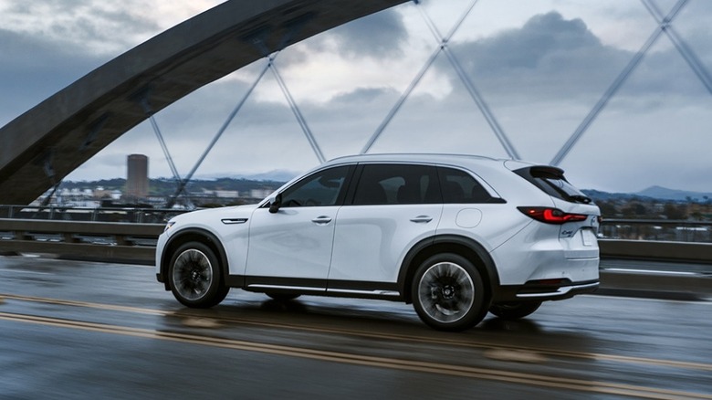 white Mazda CX-90 Plug-in Hybrid crossing a bridge