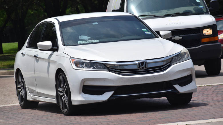 A white 2026 Honda Accord Hybrid on display.