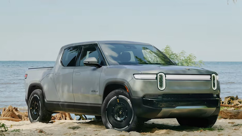 gray Rivian R1T parked on a beach