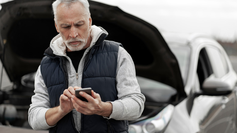 Older man calling for help after suffering car damage