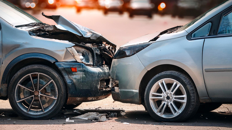 Smashed car pressed against a slightly less damaged car