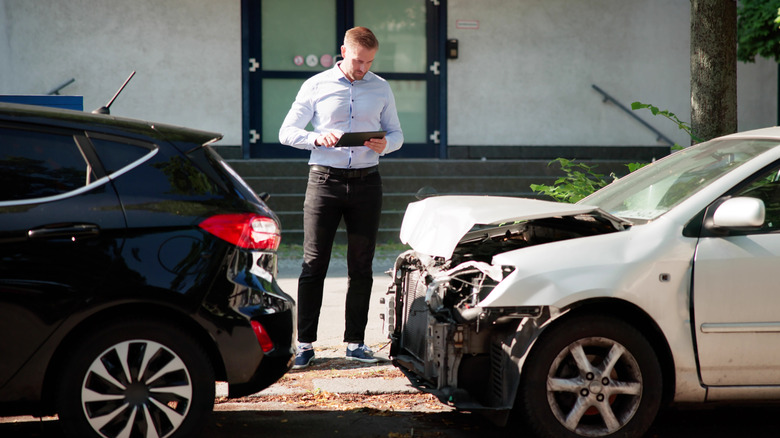 Insurance adjuster inspecting vehicles after a crash