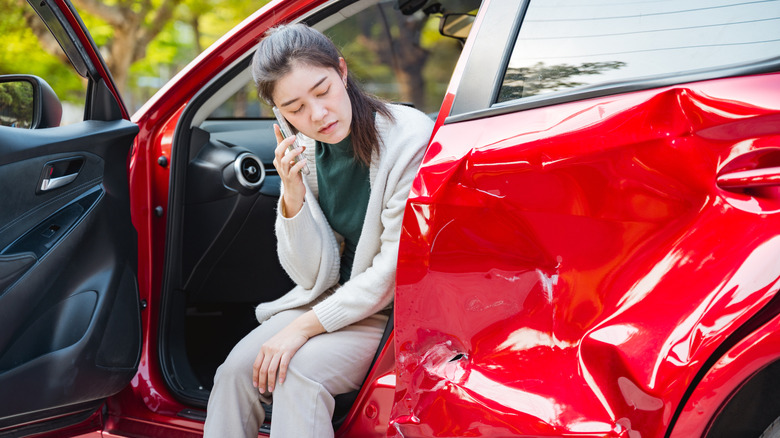 Woman on the phone after a car accident