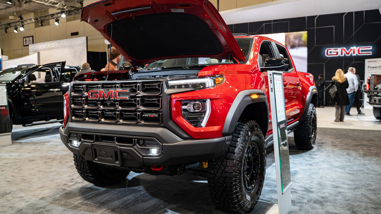 Red GMC Canyon pickup on display at a car show