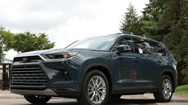 A grey blue Toyota Grand Highlander parked.