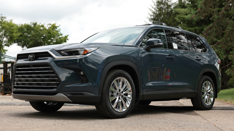 A grey blue Toyota Grand Highlander parked.